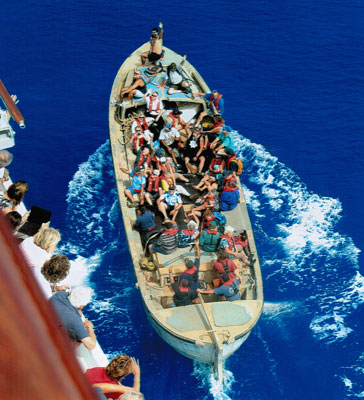 Passengers on the ship wave good-bye to the Pitcairn Island residents who had come out to visit us on board.