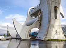 The Falkirk Wheel, the world’s only rotating boat lift, connects the Forth & Clyde and Union canals in central Scotland. Visitors can take a round-trip boat ride, ascending and descending through the wheel, in an hour.