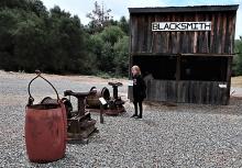 Fyllis Block inspecting blacksmith shop hardware at the Coarsegold Historic Museum in Coarsegold, California. Photos by Victor Block