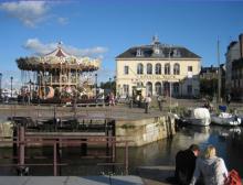 Colorful carousel at Honfleur&rsquo;s old port.