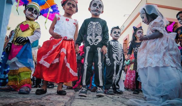 Children pausing during a parade through the streets of Oaxaca.