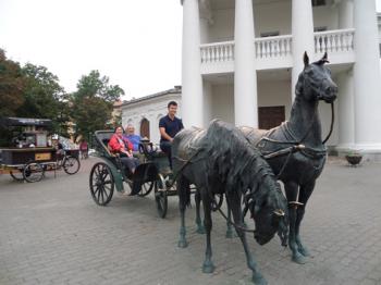 Patti and Tony Leisner horsing around with a statue in Minsk, Belarus. Photo by  Dimitar Tanevski