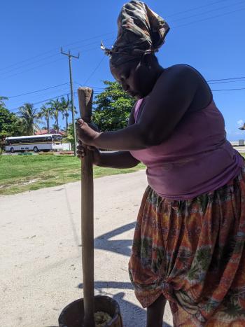 Kimberly pounding the plantains.