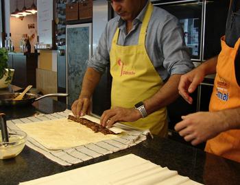 Rolling up the phyllo dough before baking.
