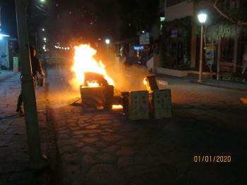 A monigote burning in a street in Puerto Villamil after New Year's Eve's midnight. Photo by Rod Smith