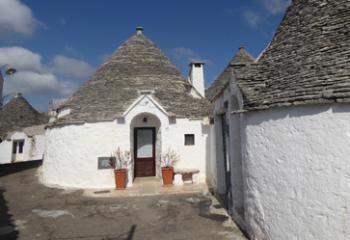 A few <i>trulli</i> are still lived in, but most are now B&Bs or shops — Alberobello.