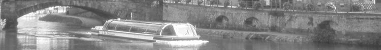 Excursion boats cruise through Strasbourg on the River Ill.