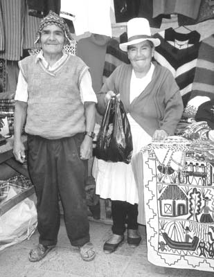 A couple sells rugs and sweaters at the Pisac market.