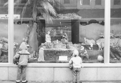 Two of Roma Hoff’s children look at her “big” nativity scene in an Eau Claire, Wisconsin, department store window in 1964. It also has been displayed in a museum.