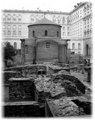 Modern buildings surround Roman ruins and a fourth-century church in central Sofia.