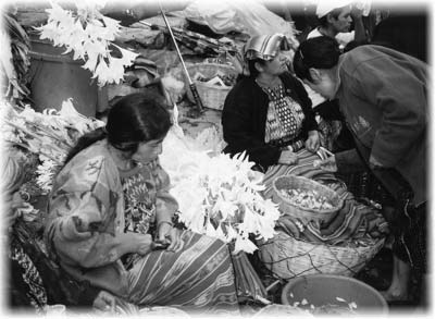 Local women selling flowers on the steps of Santo Tomás Church at the weekly market in Chichicastenango.