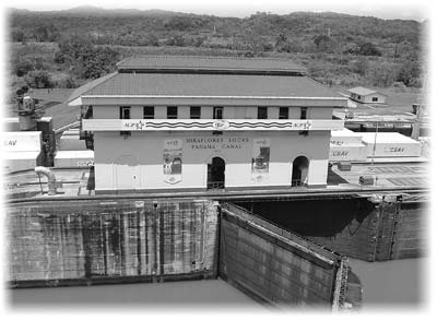 The control tower of the Miraflores Locks overlooks the ships passing on the far side of it. In 1969 we walked across this lock gate to the observation tower on a catwalk with a folding railing. Now, visitors are kept at a distance.