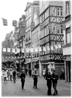 A pedestrian street in the old part of Rouen shows off Norman-style architecture.