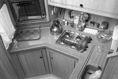 The galley aboard the Consul is small but functional. Note the most important item: a jar of American-made peanut butter brought from home. Photos: Toulmin