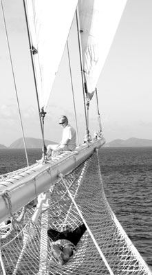 Ship’s passengers relaxing on the “Star Clipper’s” bowsprit while under way. Photo: Lew Toulmin