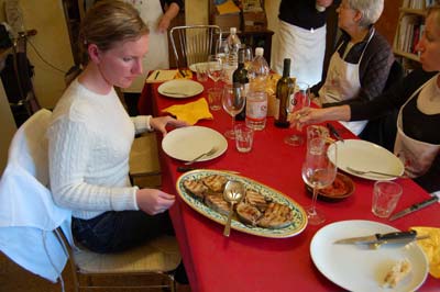 Students prepare to enjoy the fruits of their labors after a morning spent shopping and cooking. Photo by Brian McMahan.