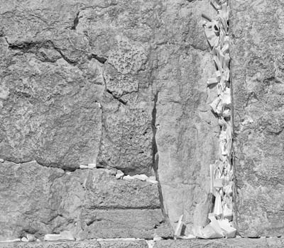 Jew, Christian and tourist alike insert written prayers between the stones in the Western Wall. — Photos by Roger Canfield