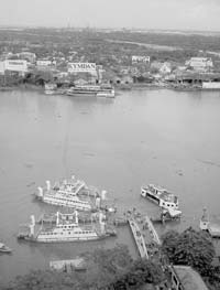 Motorbike-laden ferries crossing the Saigon River in seeming perpetual motion. 