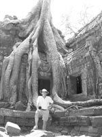 Randy beside some of the massive roots that entwine many Ta Prohm temple/monastery structures. Photo: Lin