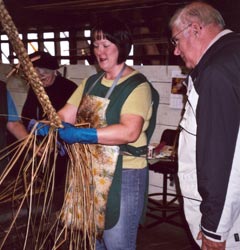 A crafter braids rushes while our English host looks on at The Waveney Rush Industry, Oulton Broad, Lowestoft.