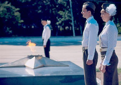 Members of the Young Honor Guard watching over a WWII memorial.