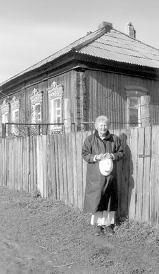 Ida Cuthbertson at a typical wooden house in Reinhard, Russia, her father’s birthplace. 