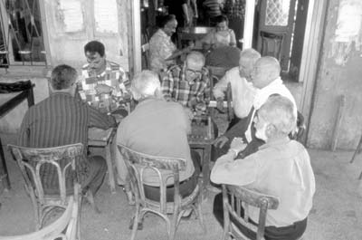 Men playing backgammon in an open-air café in Jabala.