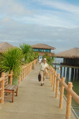 Seaside villas and long dock at Dos Palmas Resort on Arreceffi Island.