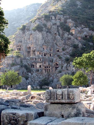 Rock tombs such as the amazing ones in Myra were built high in the cliffs around the fifth century B.C. The rugged stone faces in the foreground were carved by the Romans.