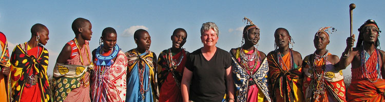 Betty Reed posing with members of a Maasai tribe.