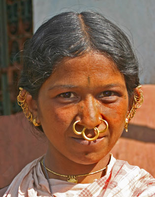 This picture was taken in a small tribal village in the Indian state of Orissa. Note the small tattoos on the woman’s forehead and chin and near her eyes.