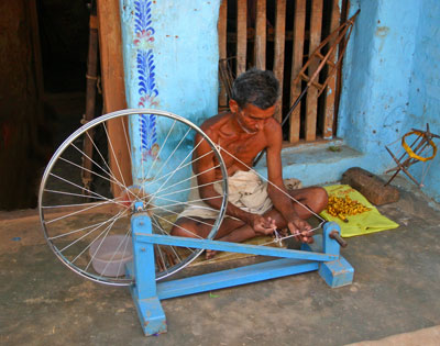 Man spinning silk in a picturesque village near Puri.