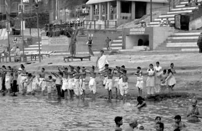 Dedicated sunrise worshipers on the banks of the revered Ganges in Varanasi.