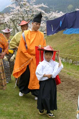 The youngest member of the Ogasawara School marches down the yabusame course as part of the opening procession of the ceremony.