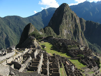 Machu Picchu is spectacularly set atop a ridge, with Huayna Picchu as a backdrop.