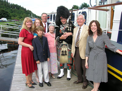 The Thomas family and their piper pose just before attending the Captain’s Dinner.