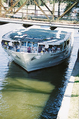 An ACCL vessel with a lowered pilothouse going under a low bridge.