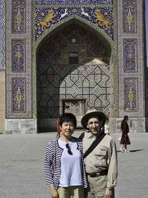 Steven Emmet and his wife, Yuki, in front of the Sherdor madrassah in Samarkand.