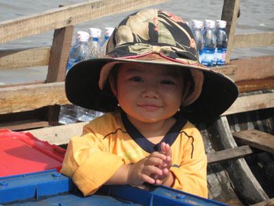 Young girl selling water at the Cai Rang floating market.