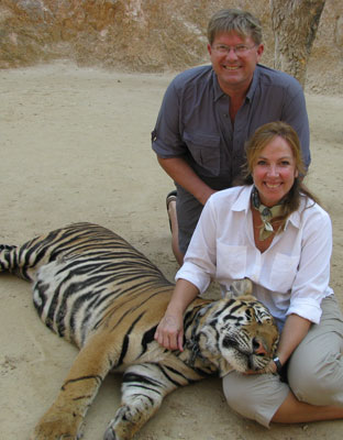 Scott Soper and Teresa O’Kane with an adult tiger after playtime in the canyon water hole.