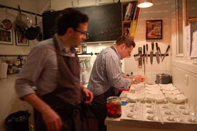 Chef Braden Perkins (front) and his intern prepare the night’s meal at Hidden Kitchen.