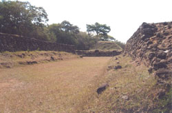 Inside the Northern Ball Court at Cihuatán. The Main Pyramid is in the background. Photos: Skurdenis