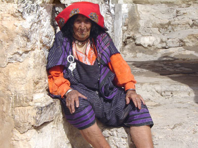 A Berber woman sits beside her home in the mountain village of Chenina.