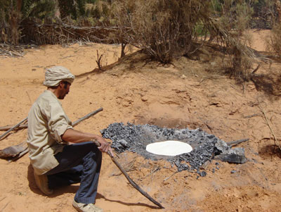 Unleavened bread baking in a campfire.