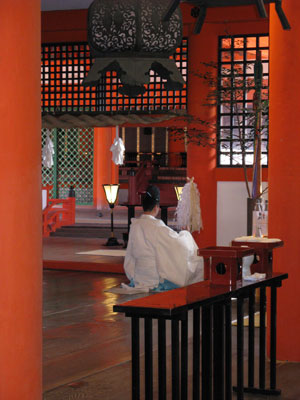 A Shinto priest performing a child’s blessing ceremony at the Itsukushima Shrine.