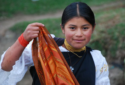 A young Ecuadoran girl selling scarves at the Otavalo market.