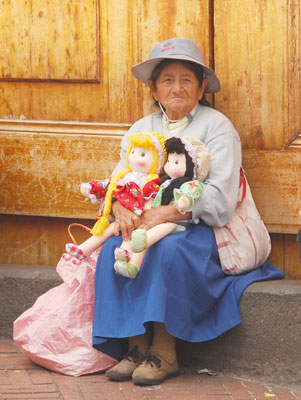 An Andean woman selling dolls in Quito’s Plaza Grande.