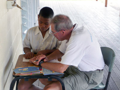 Joe helping a student with reading.