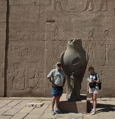 R.C. and Donna Pyle with a statue of the god Horus at the Temple of Horus in Edfu, Egypt.