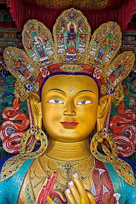 A brightly colored crowned buddha at Thiksey Monastery.